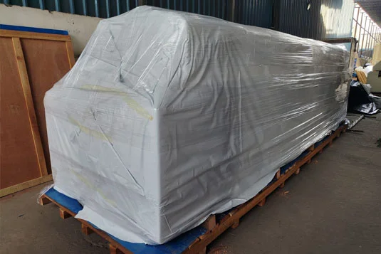 large machine is securely wrapped in industrial plastic