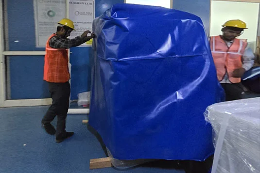 industrial packaging workers assembling heavy-duty wooden crates