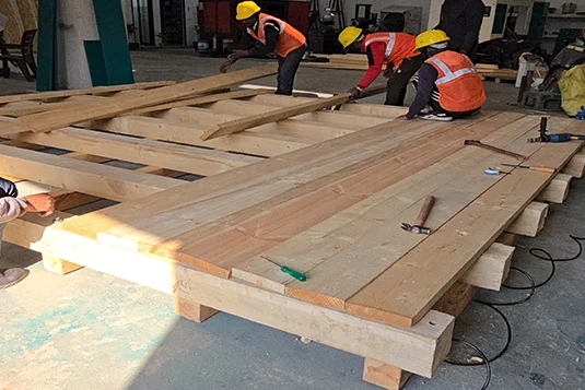 industrial workers constructing a large wooden platform