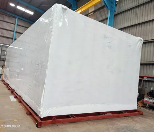 industrial heavy machinery securely wrapped in white shrink film